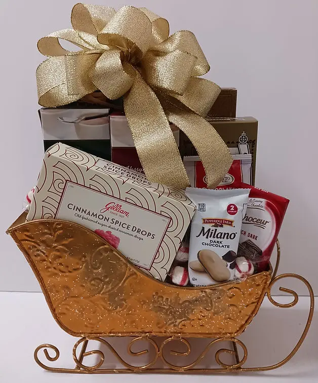 A gold sleigh filled with colorful candy, cookies, and various festive gifts.